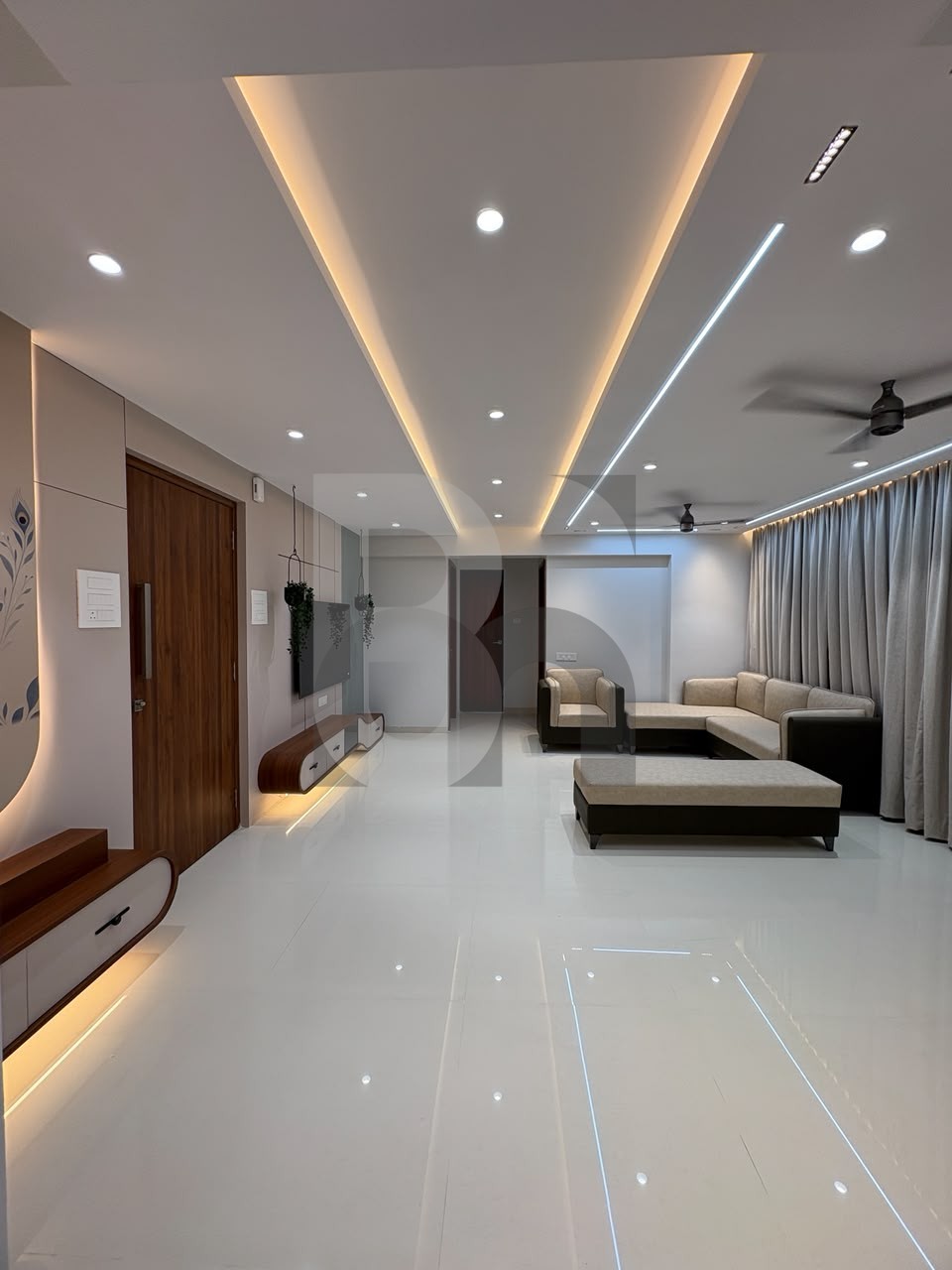 Modern open-plan living room with false ceiling and cove lighting designed by Brand Meter, Navi Mumbai