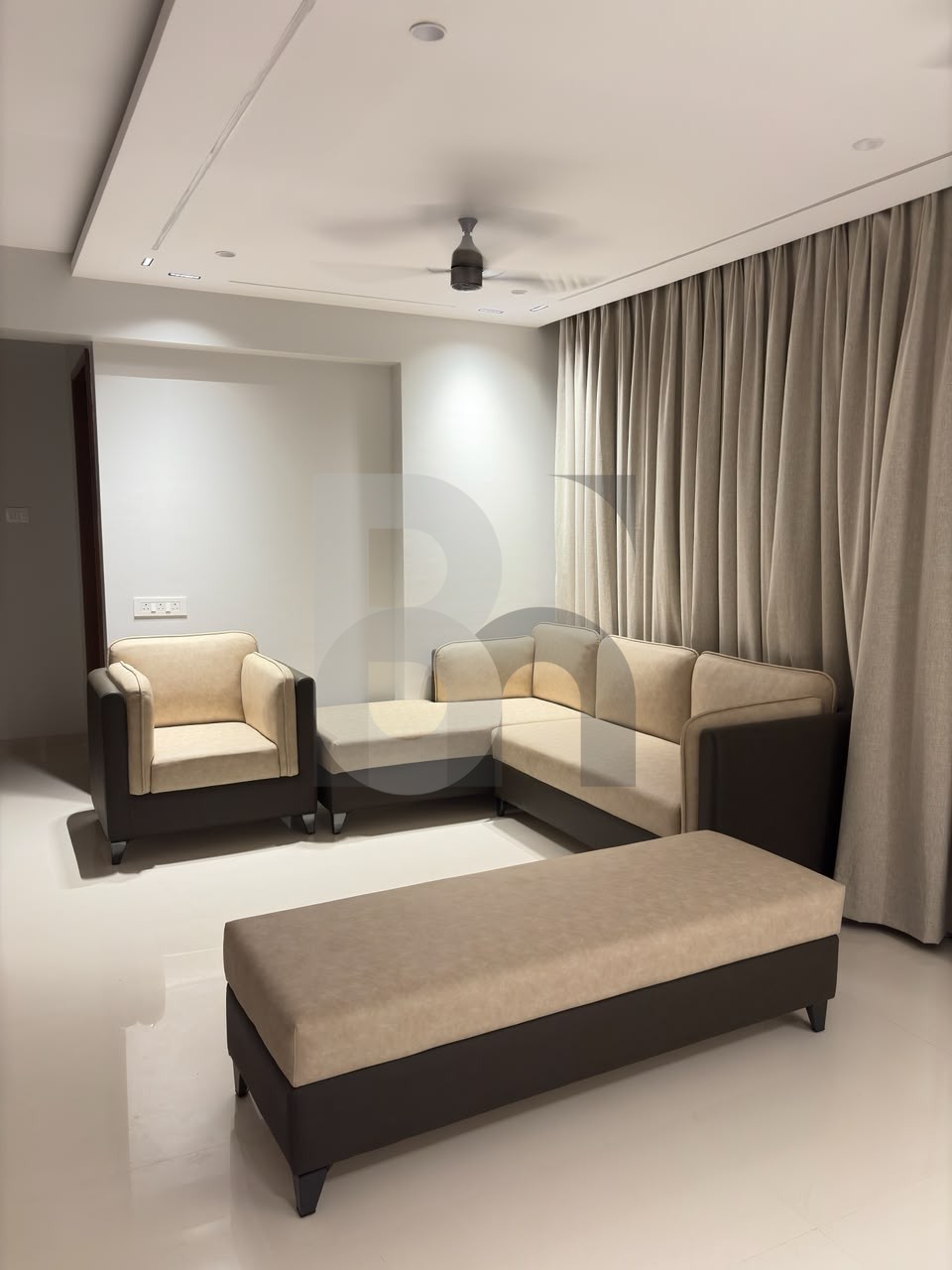 Contemporary living room with plush L-shaped sofa and recessed LED ceiling lights by Brand Meter