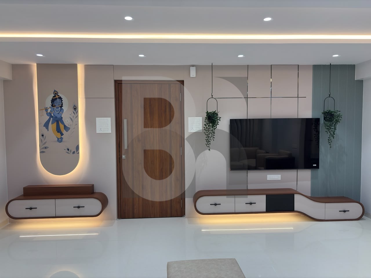 Living room feature wall with backlit Krishna art panel and floating curved TV unit by Brand Meter