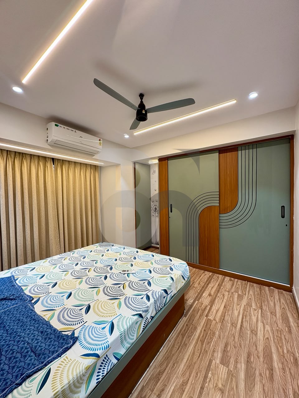 Modern bedroom with sage green dual-tone sliding wardrobe and LED ceiling light by Brand Meter