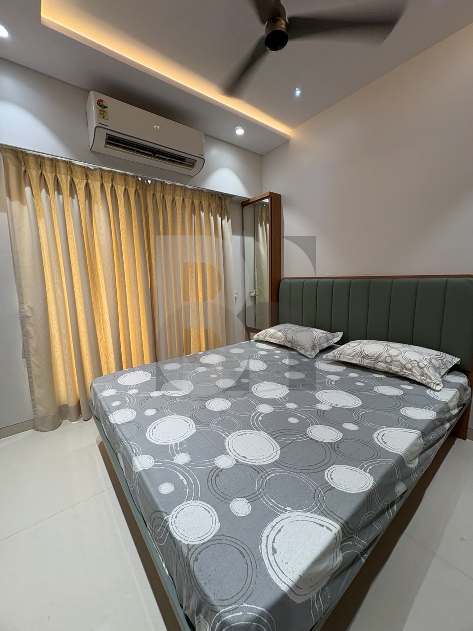 Compact bedroom with padded headboard and geometric bedding designed by Brand Meter, Navi Mumbai