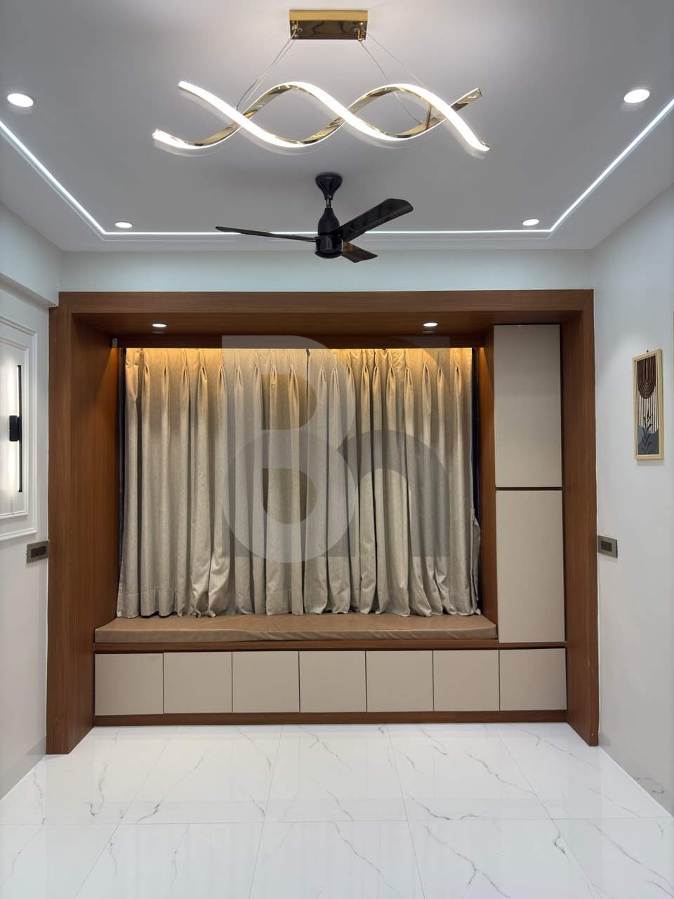 Cozy bay window sitting alcove with built-in storage and modern chandelier by Brand Meter