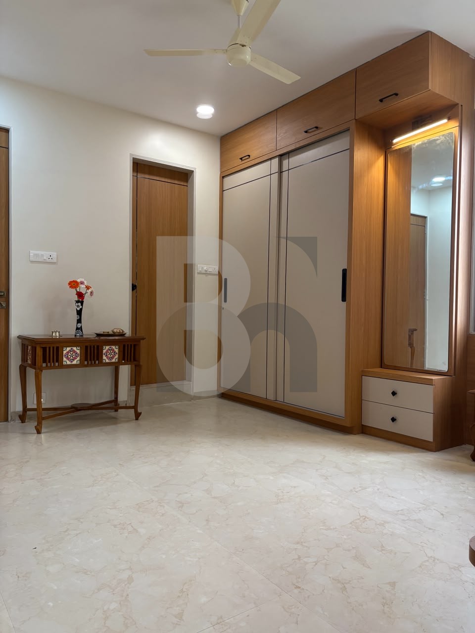 Bedroom foyer with floor-to-ceiling sliding wardrobe and integrated dressing mirror by Brand Meter