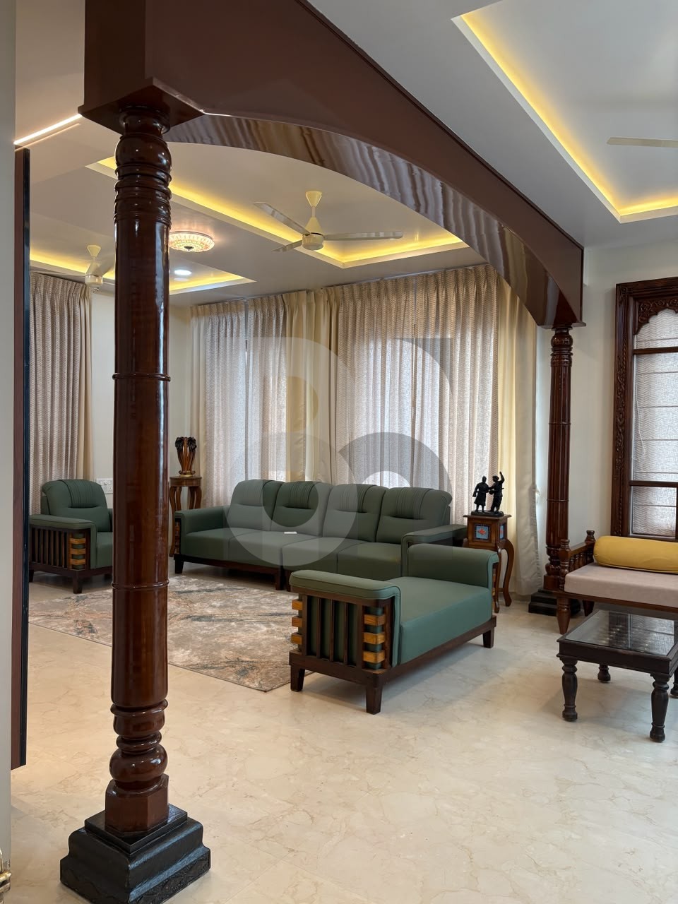 Traditional luxury living room with carved wood pillar arches and olive green sofa set by Brand Meter