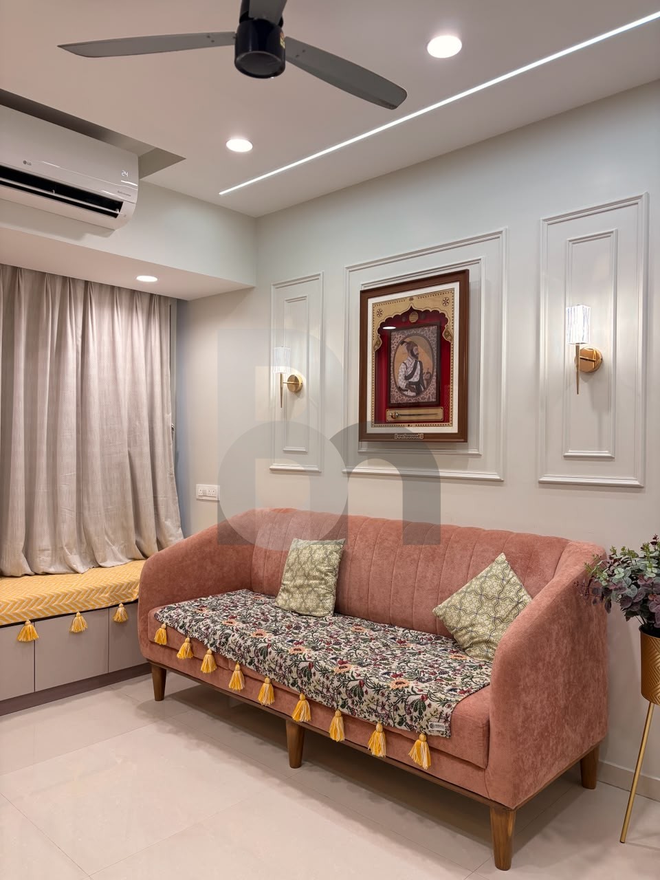 Elegant living room with dusty rose velvet sofa and classical wall molding panels by Brand Meter, Vashi
