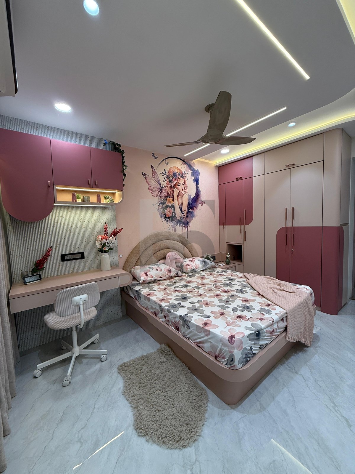 Cozy girls bedroom with custom floating study desk, fairy wall painting, and ambient LED lighting by Brand Meter