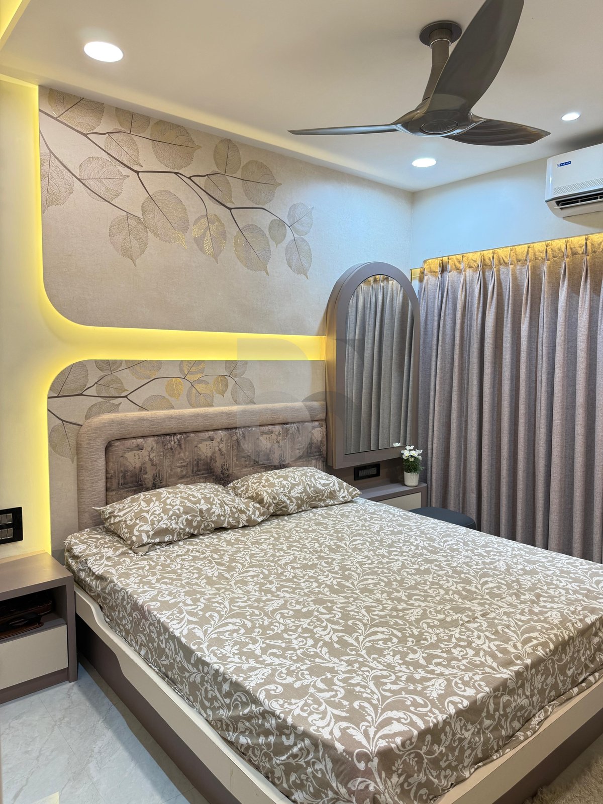 Luxury master bedroom with illuminated botanical panel, arched vanity mirror, and bedside table by Brand Meter