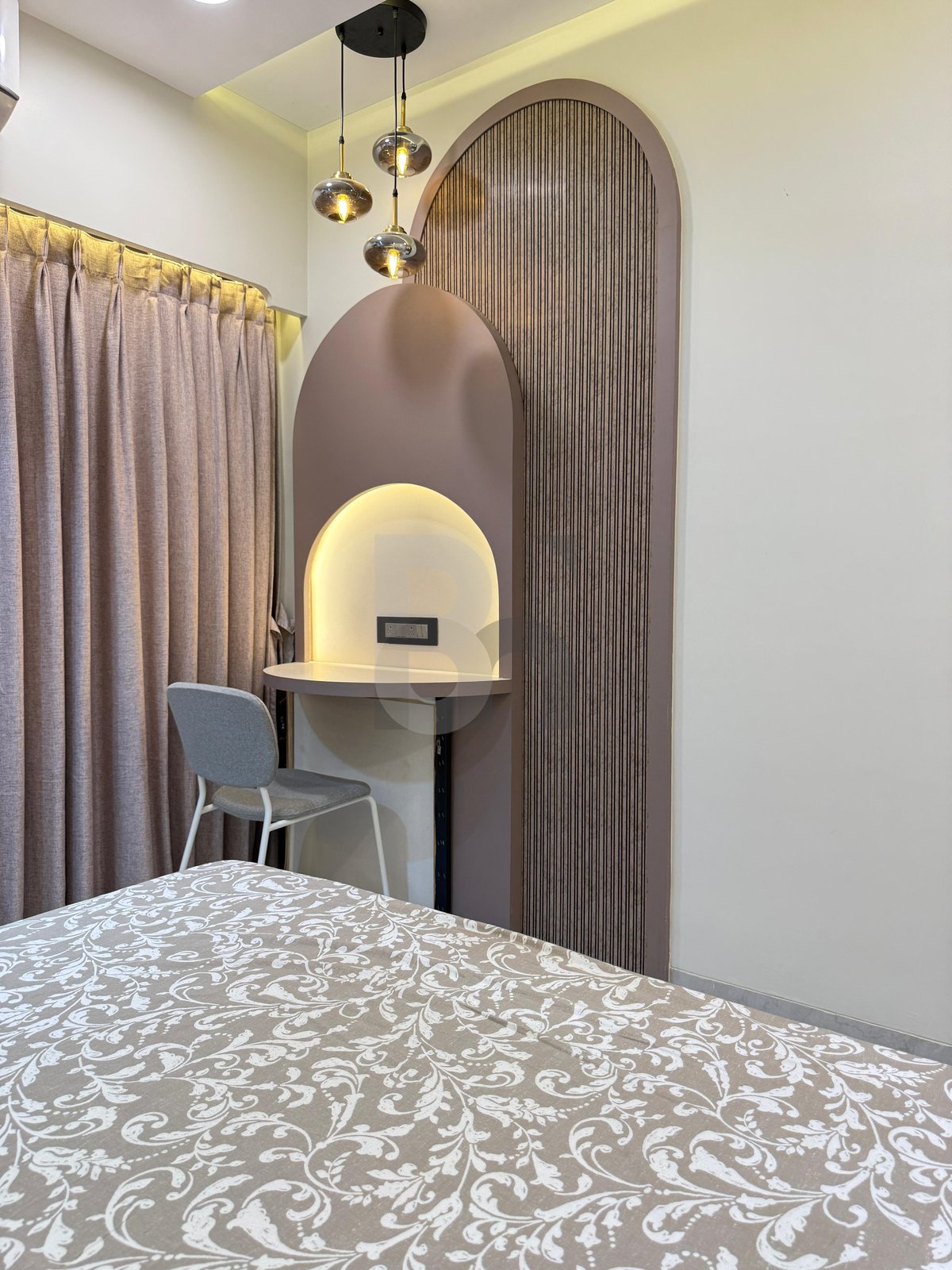 Dressing vanity alcove with fluted wooden arch, hanging globe pendant lights, and mirror by Brand Meter
