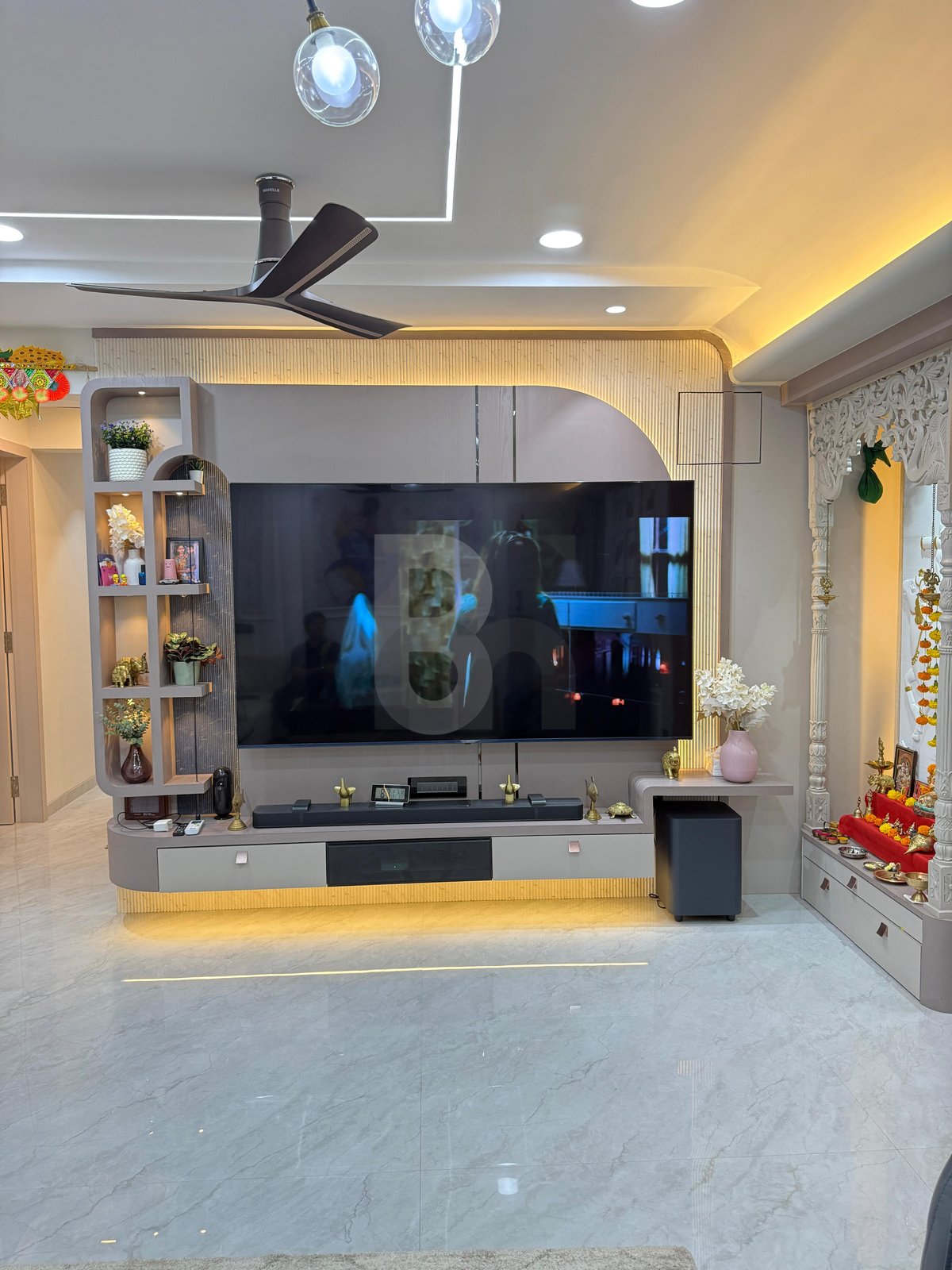 Living room TV console with integrated marble pooja mandir and backlit display shelving by Brand Meter