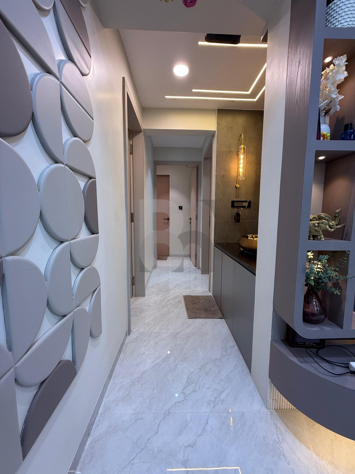 Apartment passage corridor with geometric feature wall and built-in illuminated display niches by Brand Meter